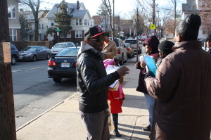 Hassan Manning, president of the Maple Avenue School PTA, hands out petitions