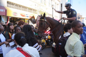 Students hold the line against efforts by mounted policeman to break through