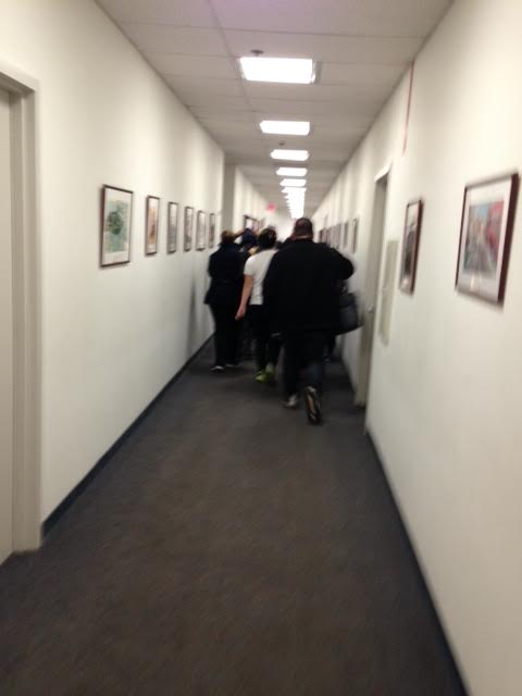 Newark students sprint down long eighth-floor hallway to get to Anderson's offices ahead of security officers